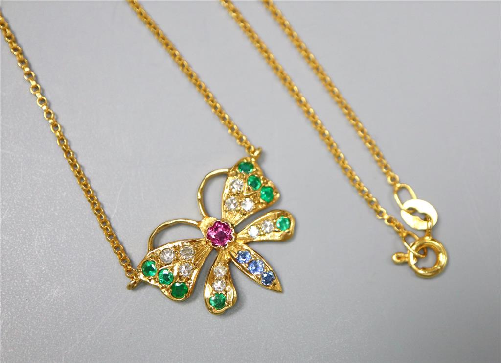 A modern 9ct gold, ruby, emerald, sapphire and diamond set butterfly pendant necklace, 45cm, gross 2.8 grams.